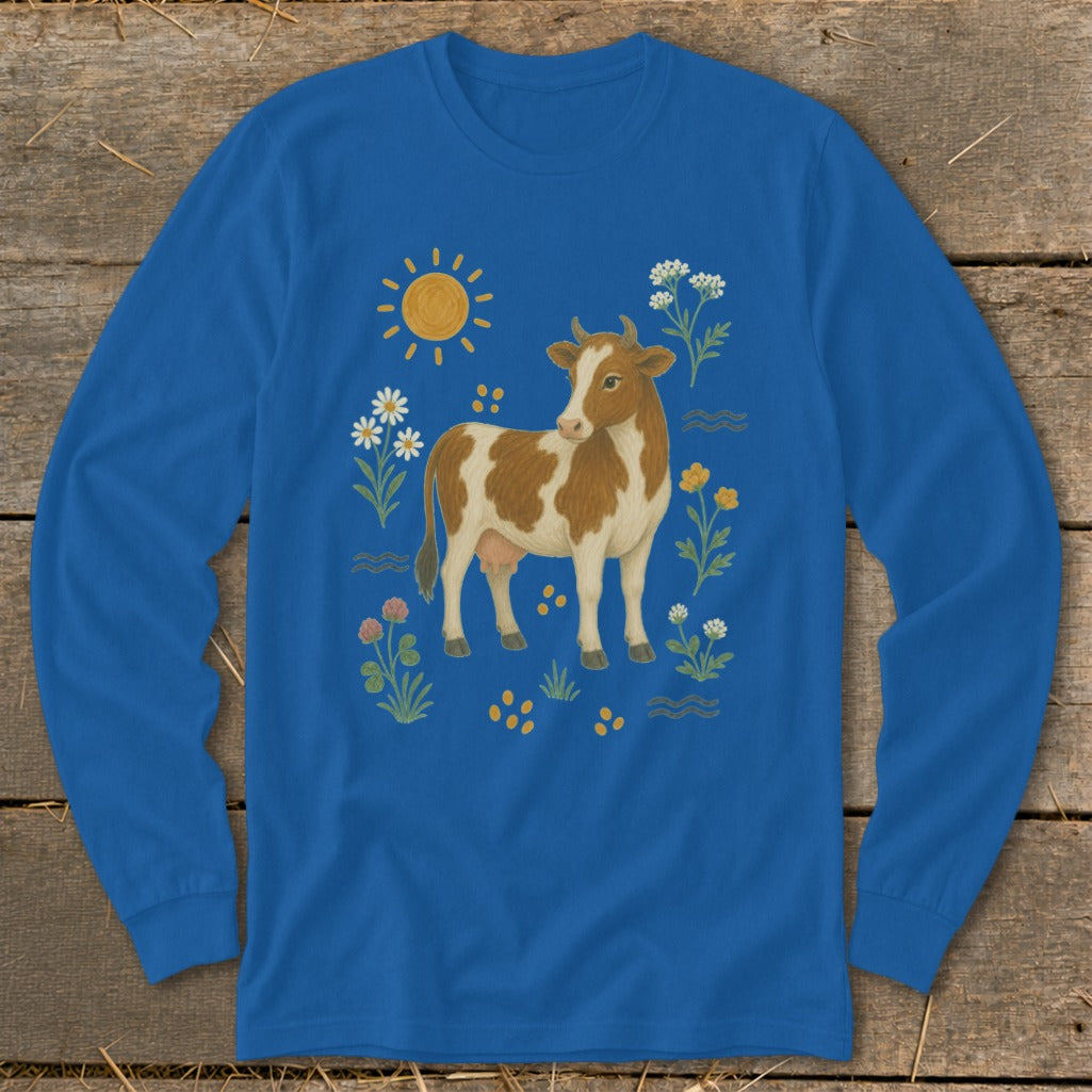 Blue long-sleeved shirt with a brown and white cow, sun, and wildflowers design.
