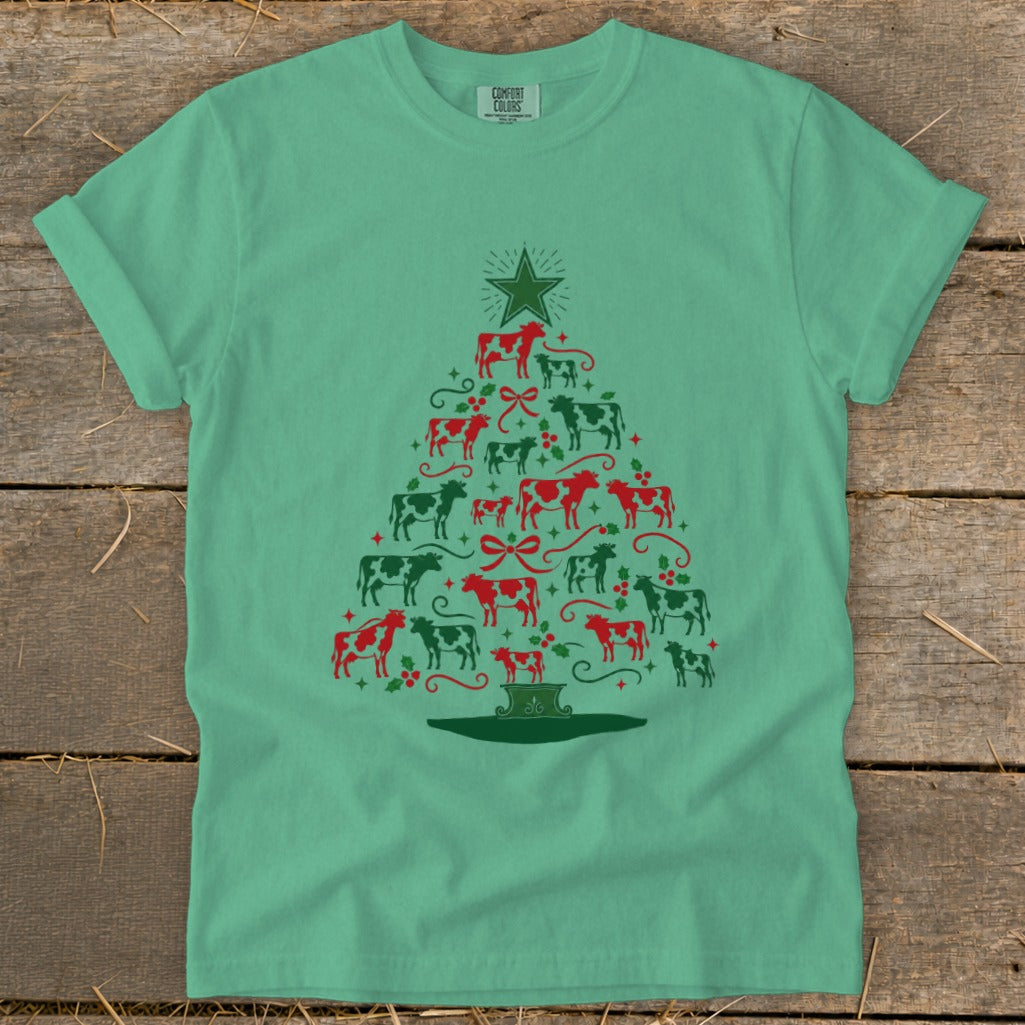 Teal t-shirt with a Christmas tree design made of red and green cows.