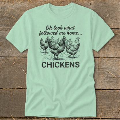 Light blue t-shirt with drawing of chickens and text "Oh look what followed me home... CHICKENS".