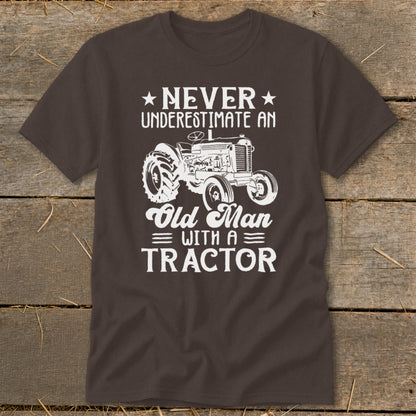 Brown t-shirt with white text and tractor graphic: Never Underestimate An Old Man With A Tractor.