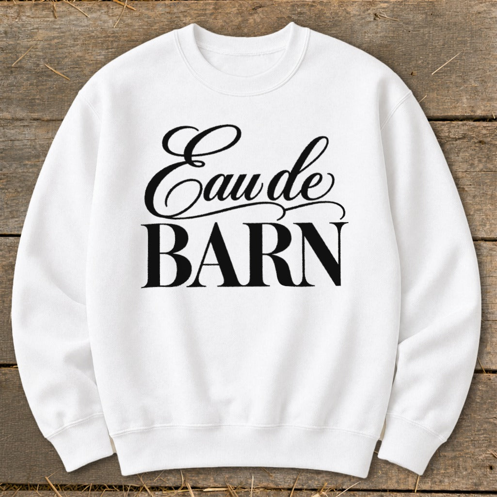 White sweatshirt with "Eau de BARN" text in black script and block font.