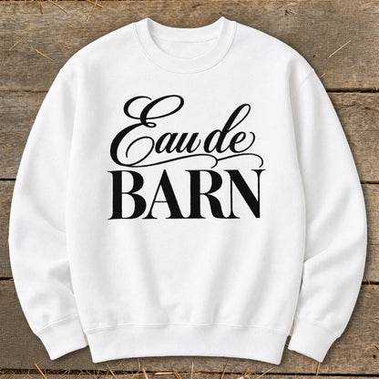 White sweatshirt with "Eau de BARN" text in black script and block font.