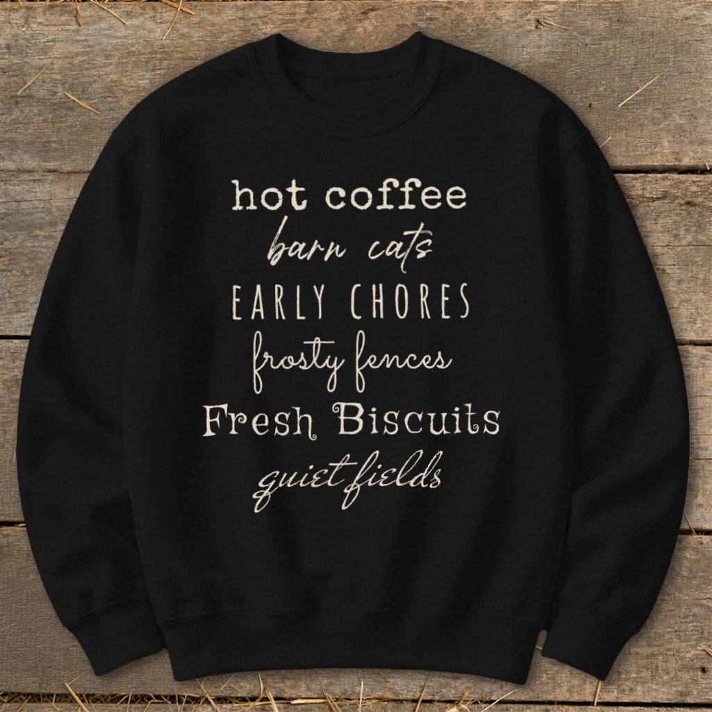 Black sweatshirt with text: hot coffee, barn cats, EARLY CHORES, frosty fences, Fresh Biscuits, quiet fields.