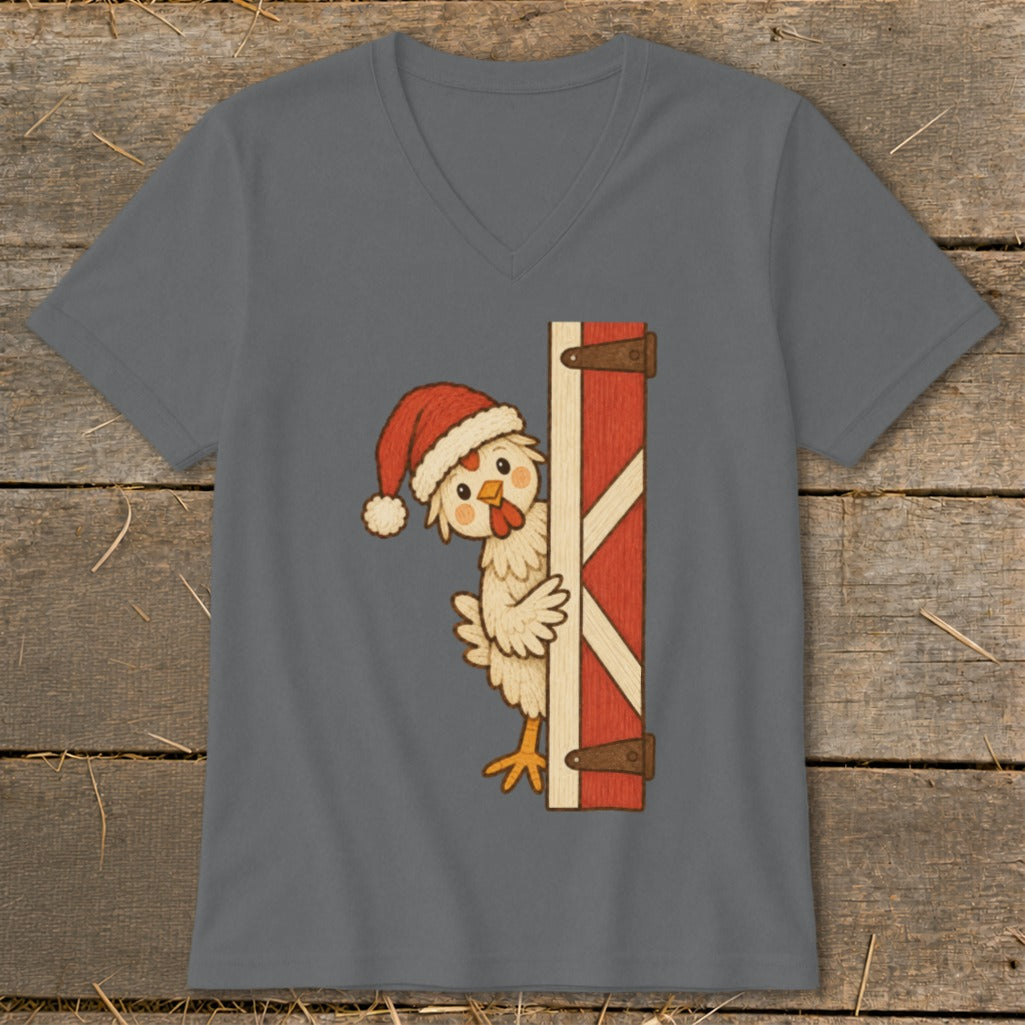 Cartoon chicken wearing Santa hat peeks from behind a barn door.