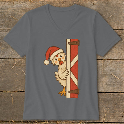 Cartoon chicken wearing Santa hat peeks from behind a barn door.