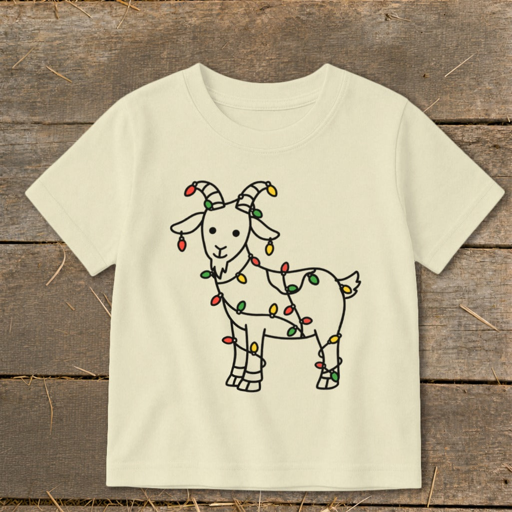 Cream t-shirt with a black outline drawing of a goat wrapped in colorful Christmas lights.
