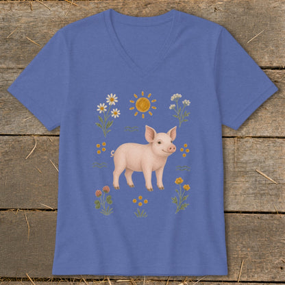 Piglet surrounded by flowers, clover, and a smiling sun illustration on a blue v-neck t-shirt.