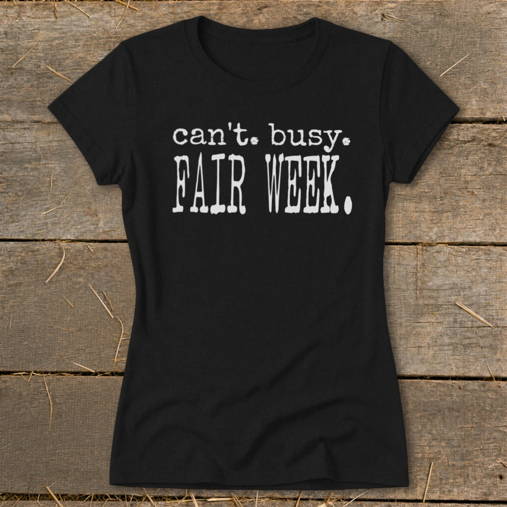 Black t-shirt with "can't. busy. FAIR WEEK." printed in white.