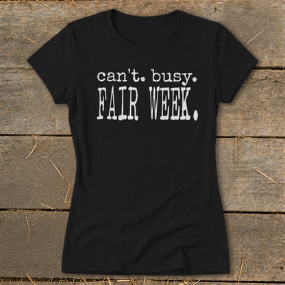 Black t-shirt with "can't. busy. FAIR WEEK." printed in white.