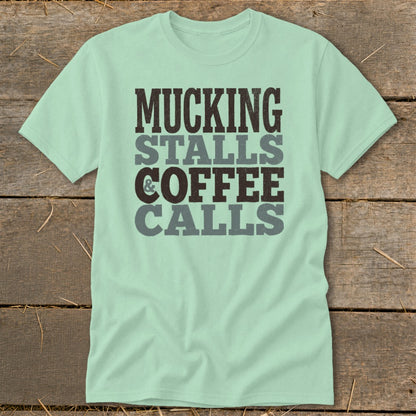 Mint green t-shirt with text: Mucking Stalls & Coffee Calls.