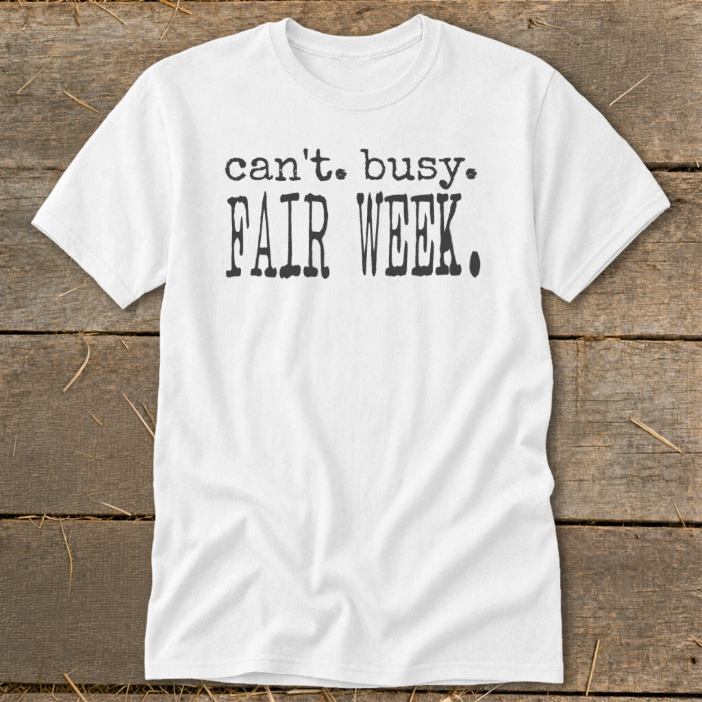 White t-shirt with black text that reads "can't. busy. FAIR WEEK."