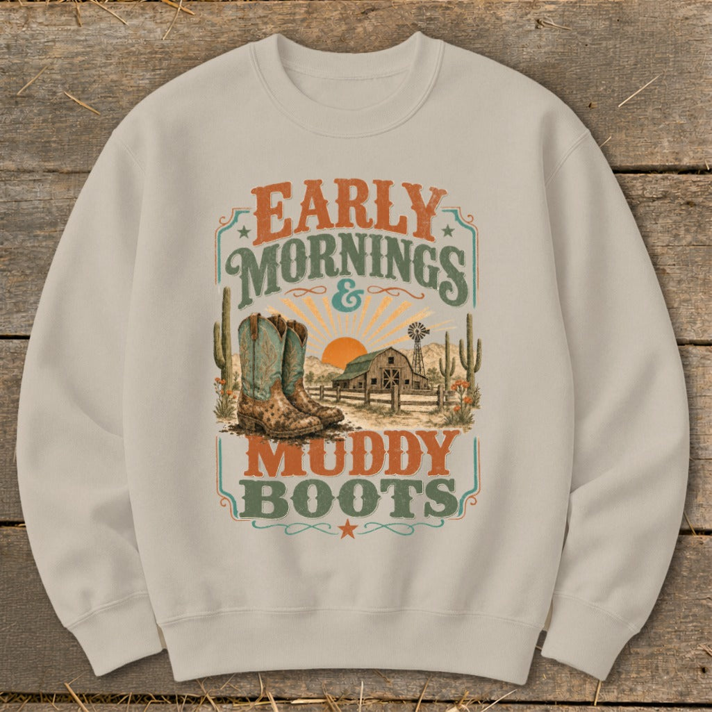 Cream sweatshirt with "Early Mornings & Muddy Boots" text and cowboy boot, barn, and cactus graphic.