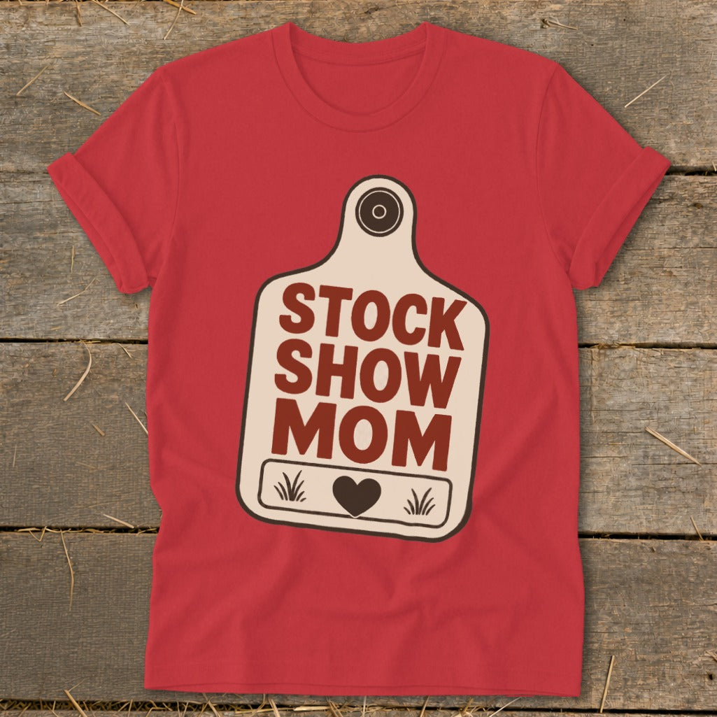 Red t-shirt with a cream-colored tag graphic reading "STOCK SHOW MOM" and a heart.