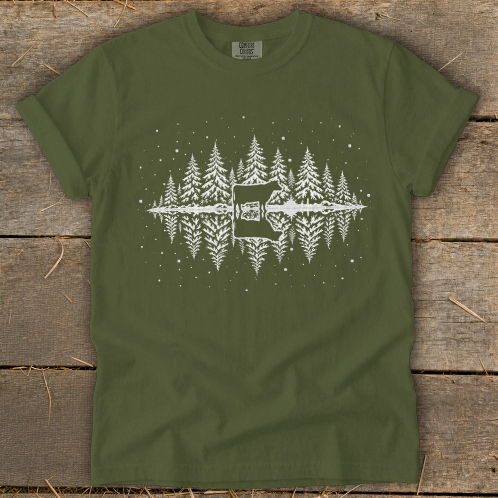Green t-shirt with white graphic of pine trees reflected in water and a guitar silhouette.