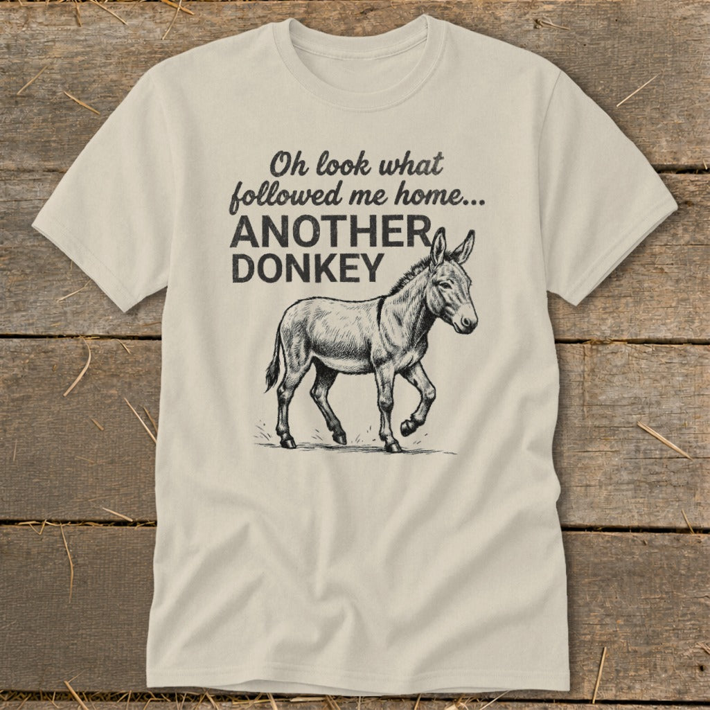Light-colored t-shirt with text "Oh look what followed me home... ANOTHER DONKEY" and a donkey illustration.