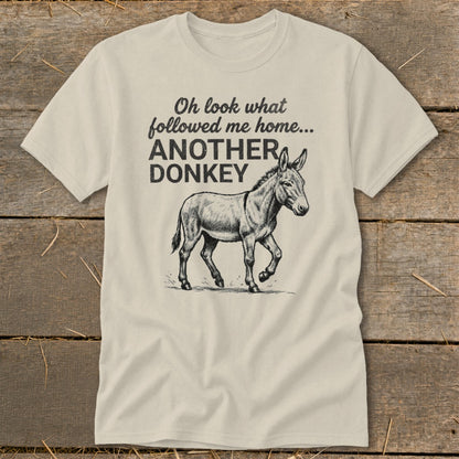 Light-colored t-shirt with text "Oh look what followed me home... ANOTHER DONKEY" and a donkey illustration.