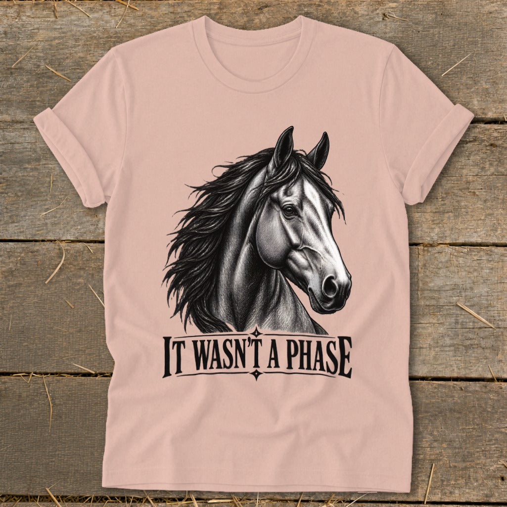Pink t-shirt with a black and white drawing of a horse's head and the text "IT WASN'T A PHASE".