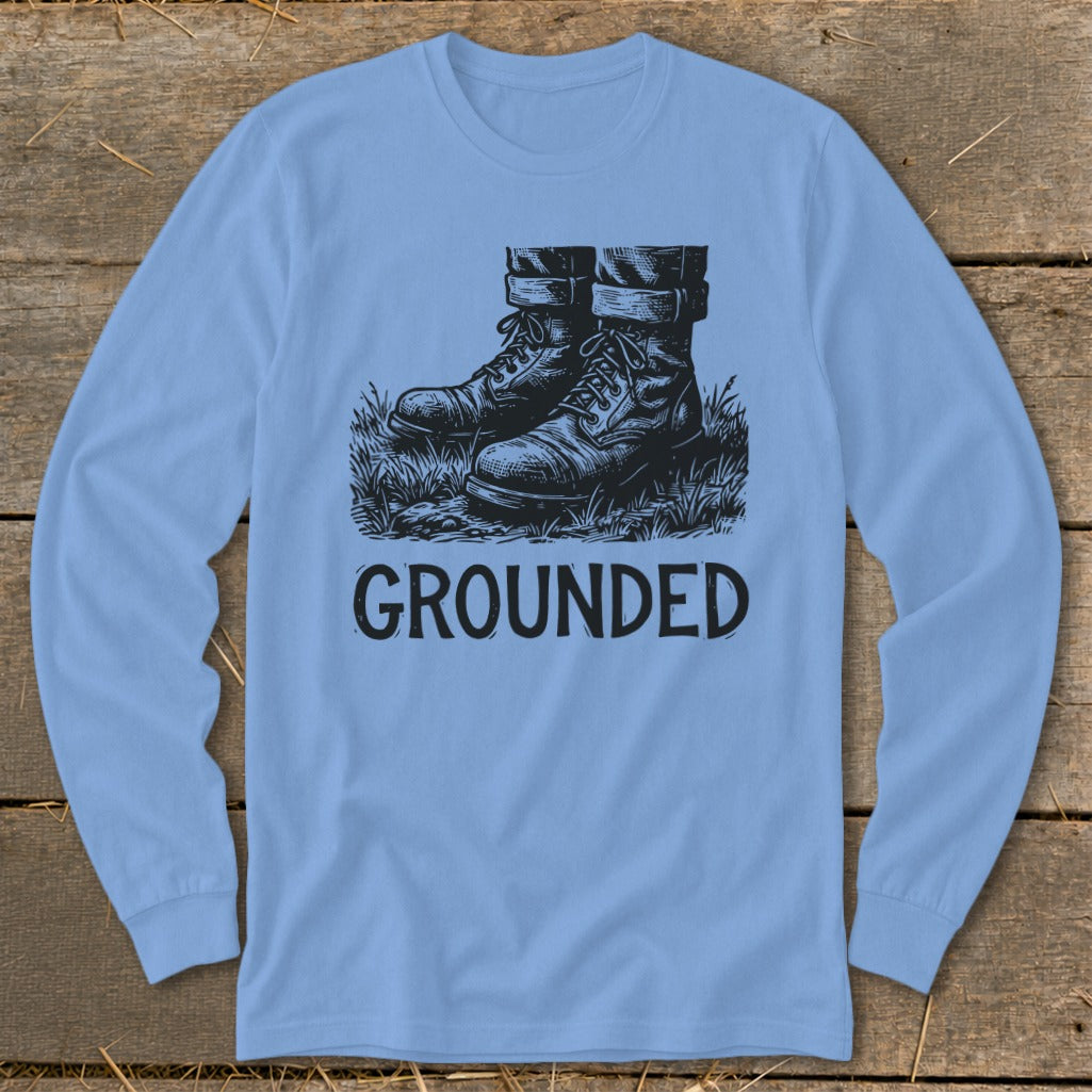 Light blue long sleeve shirt with black illustration of boots and text "GROUNDED".