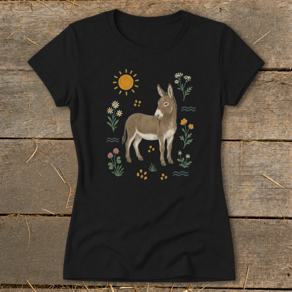 Black t-shirt with a brown donkey illustration surrounded by flowers, the sun, and wavy lines.