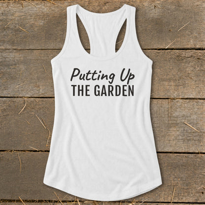 White racerback tank top with black text "Putting Up THE GARDEN".