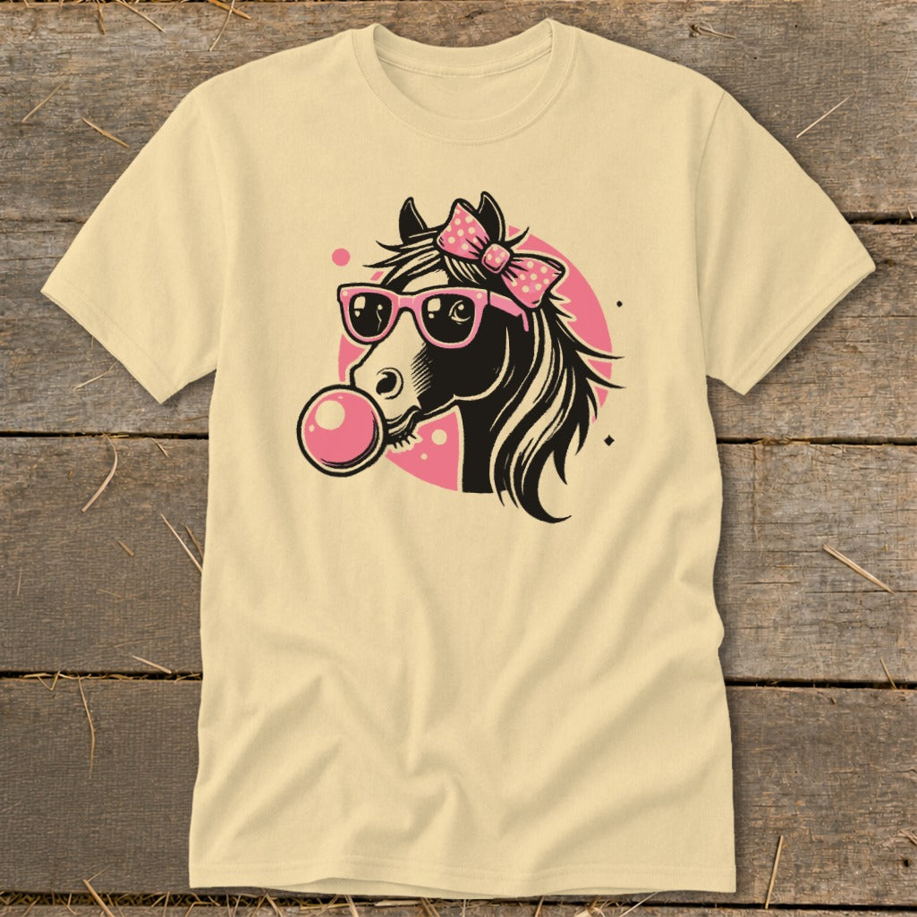 Black horse wearing pink sunglasses and bow, blowing pink bubblegum on a cream shirt.