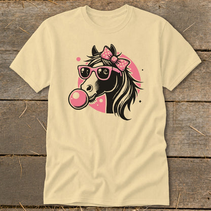 Black horse wearing pink sunglasses and bow, blowing pink bubblegum on a cream shirt.