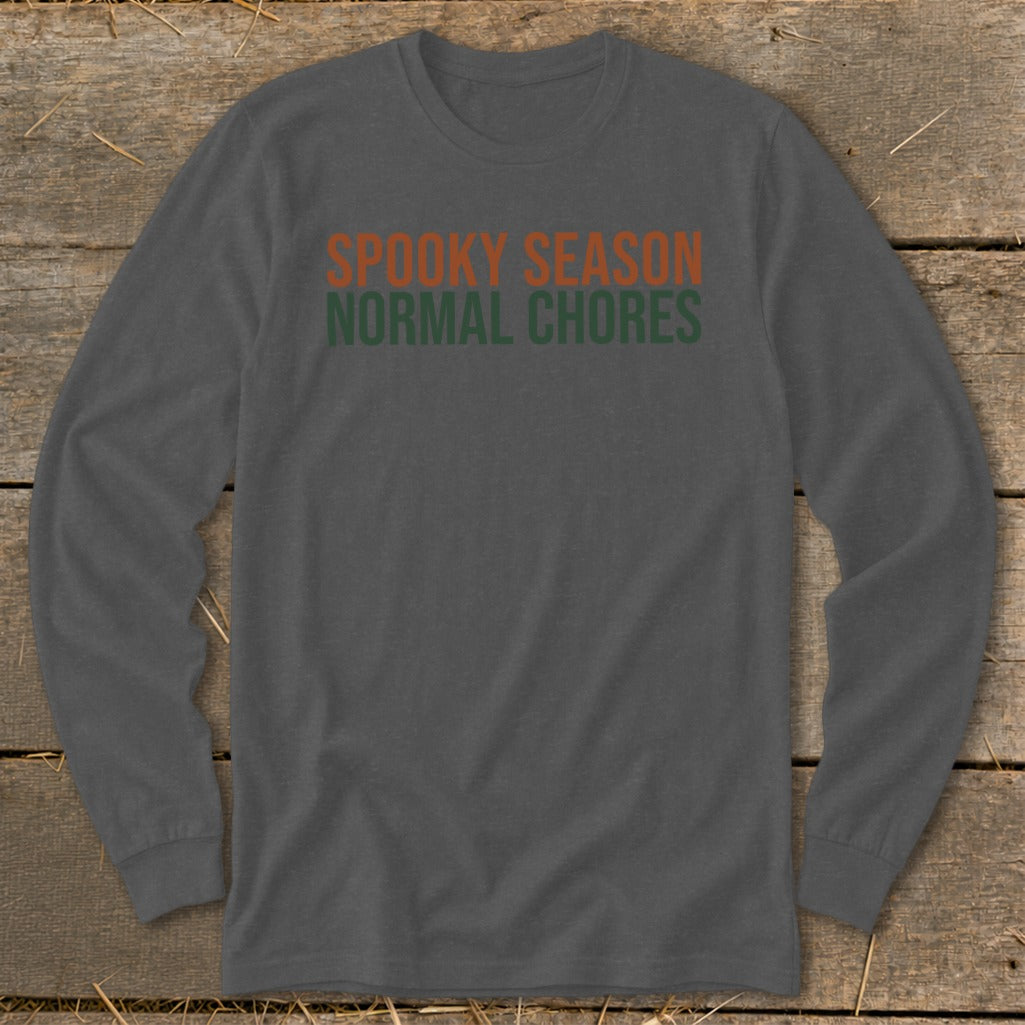 Gray long-sleeve shirt with orange and green text reading "Spooky Season Normal Chores."