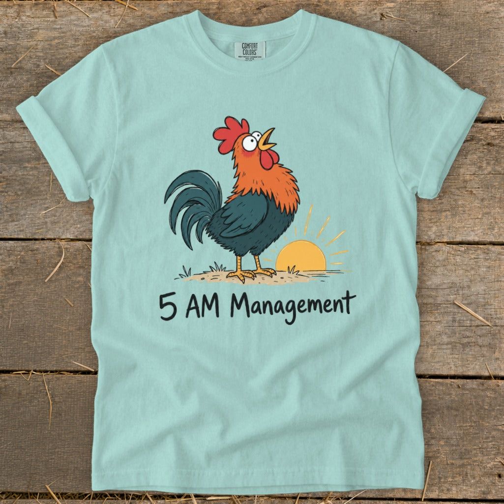 Light blue t-shirt with cartoon rooster, sunrise, and "5 AM Management" text.