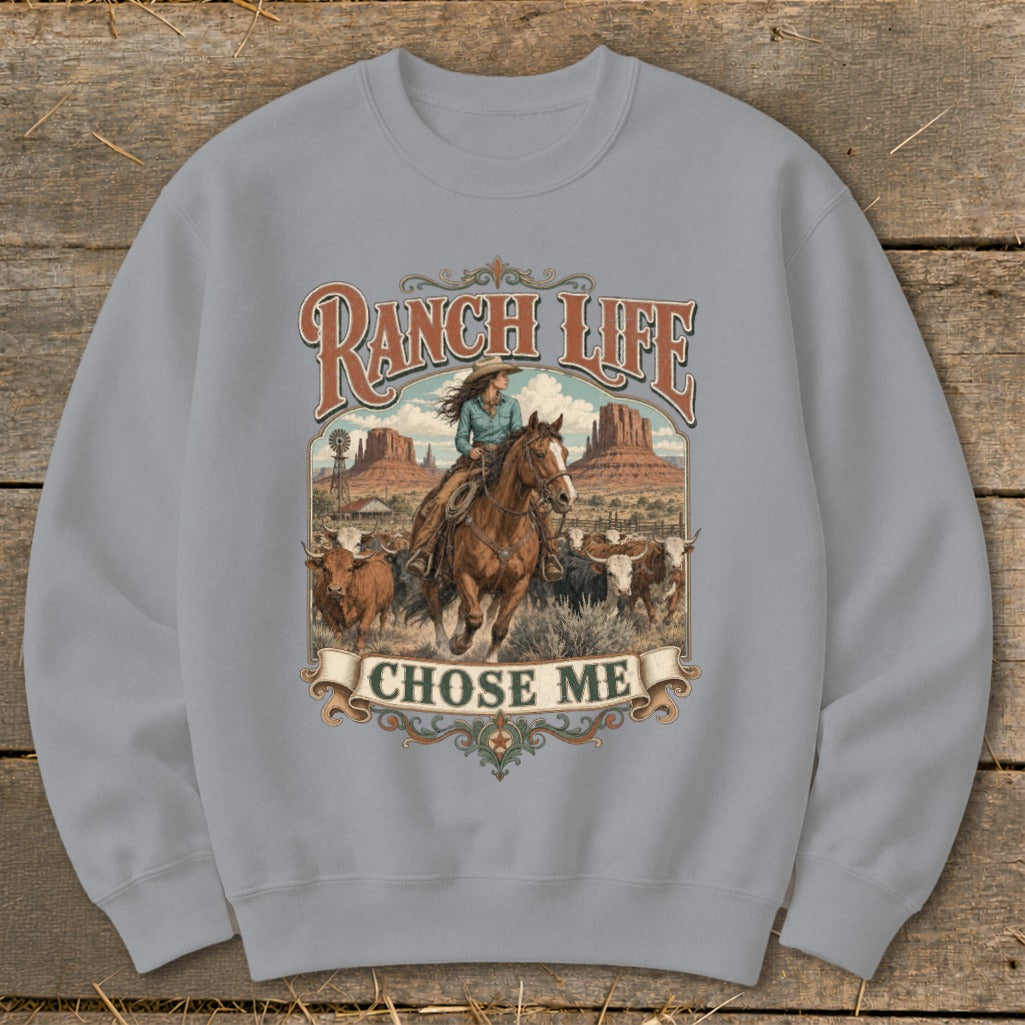 Ranch Life Chose Me graphic on sweatshirt with cowboy riding horse and cows.