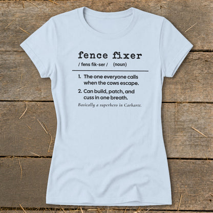 Light blue t-shirt with "Fence Fixer" definition including cows escaping and superhero mention.