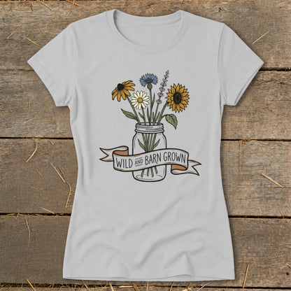 Light gray t-shirt with a mason jar of wildflowers and text that reads "WILD AND BARN GROWN".