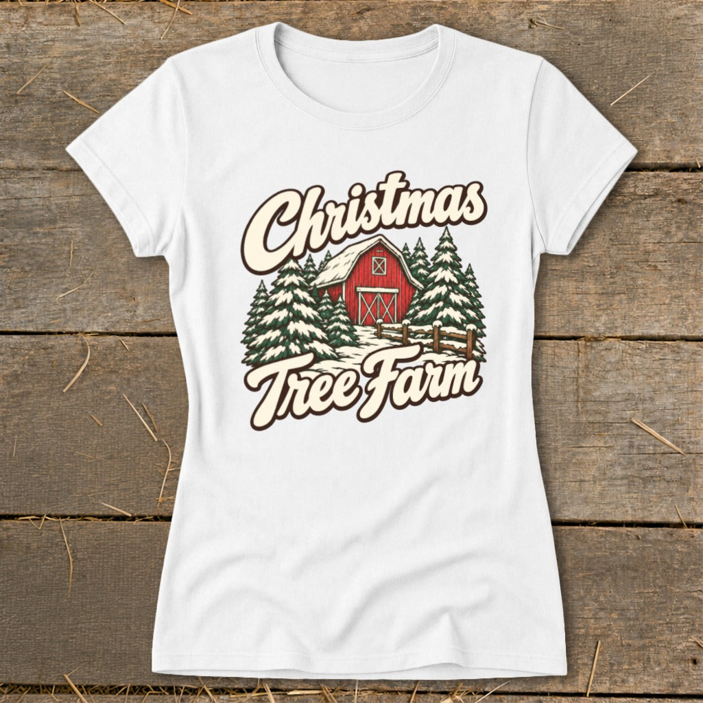 White t-shirt with "Christmas Tree Farm" text, red barn, and pine trees graphic.