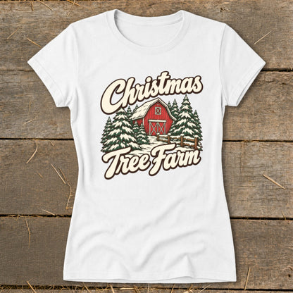 White t-shirt with "Christmas Tree Farm" text, red barn, and pine trees graphic.