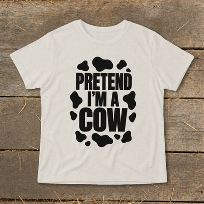 Light-colored t-shirt with "PRETEND I'M A COW" and black cow spots design.