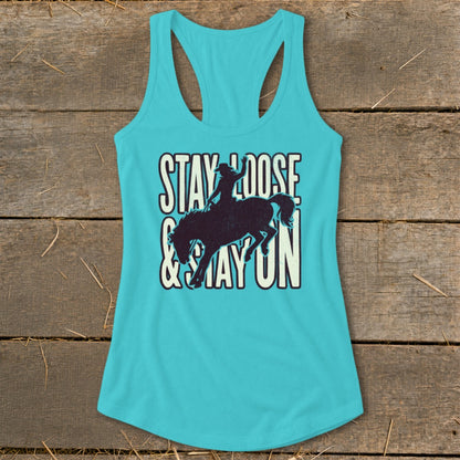 Turquoise tank top with "Stay Loose & Stay On" text and bucking bronco graphic.