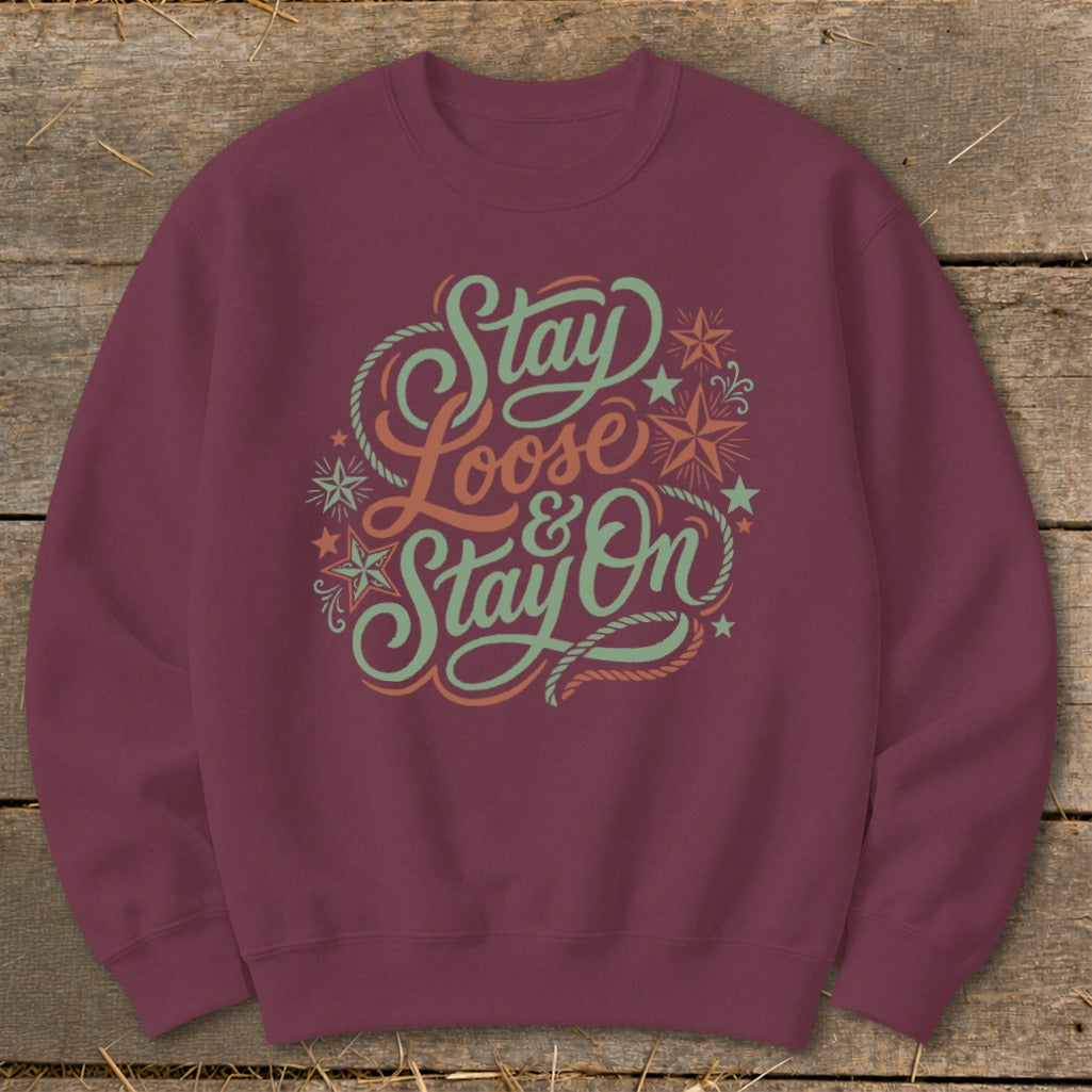 Maroon sweatshirt with "Stay Loose & Stay On" text and decorative elements.