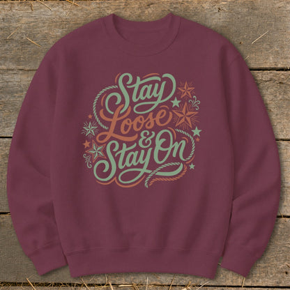 Maroon sweatshirt with "Stay Loose & Stay On" text and decorative elements.