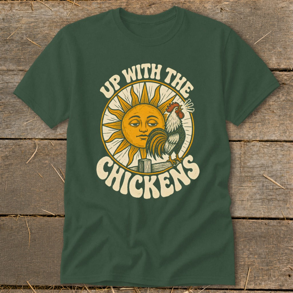 A dark green t-shirt displays a graphic of a rooster crowing before a smiling sun with text reading Up With The Chickens.