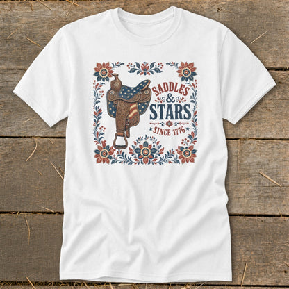 White t-shirt with western saddle graphic and "Saddles & Stars Since 1776" text.