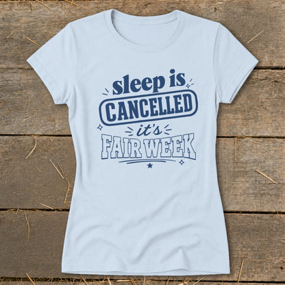 Light blue t-shirt with navy text reading "sleep is CANCELLED it's FAIR WEEK".
