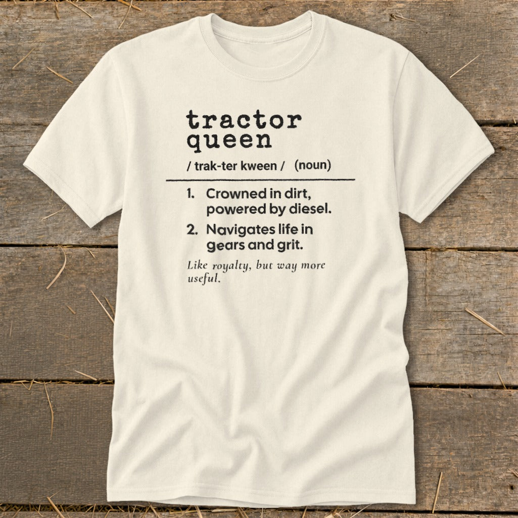Cream t-shirt with "tractor queen" definition: crowned in dirt, powered by diesel, navigates life in gears and grit.