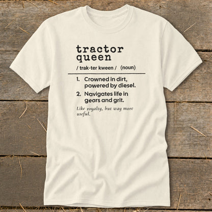 Cream t-shirt with "tractor queen" definition: crowned in dirt, powered by diesel, navigates life in gears and grit.
