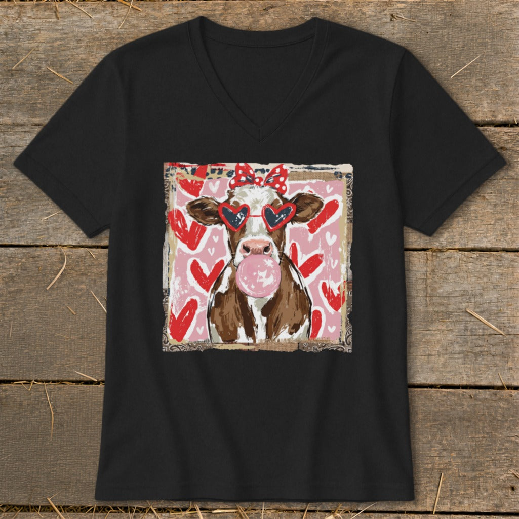Cow wearing heart sunglasses and a bow, blowing bubblegum on a pink background with hearts.