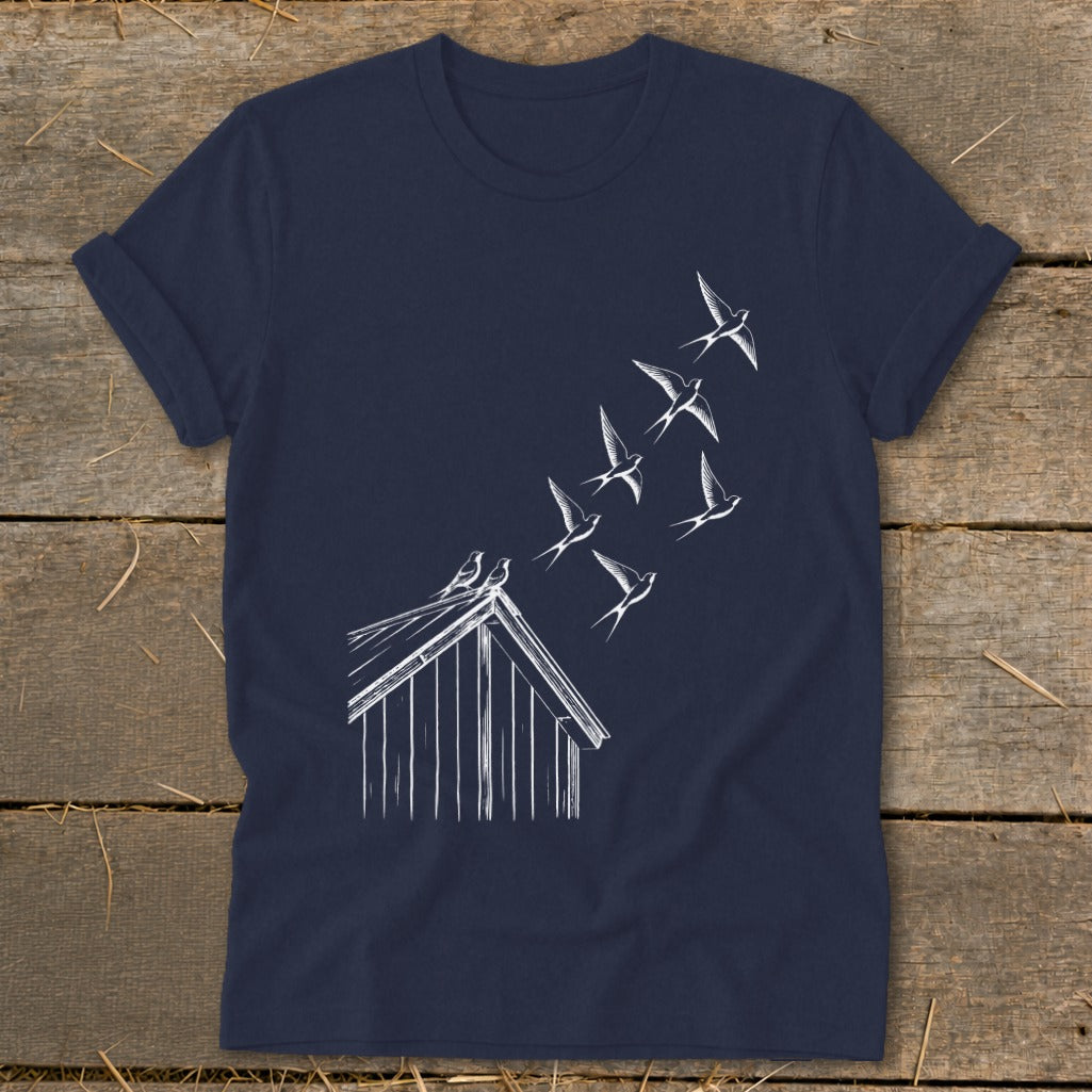 A navy blue t-shirt featuring a white line drawing of birds flying from a barn roof.