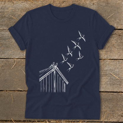 A navy blue t-shirt featuring a white line drawing of birds flying from a barn roof.