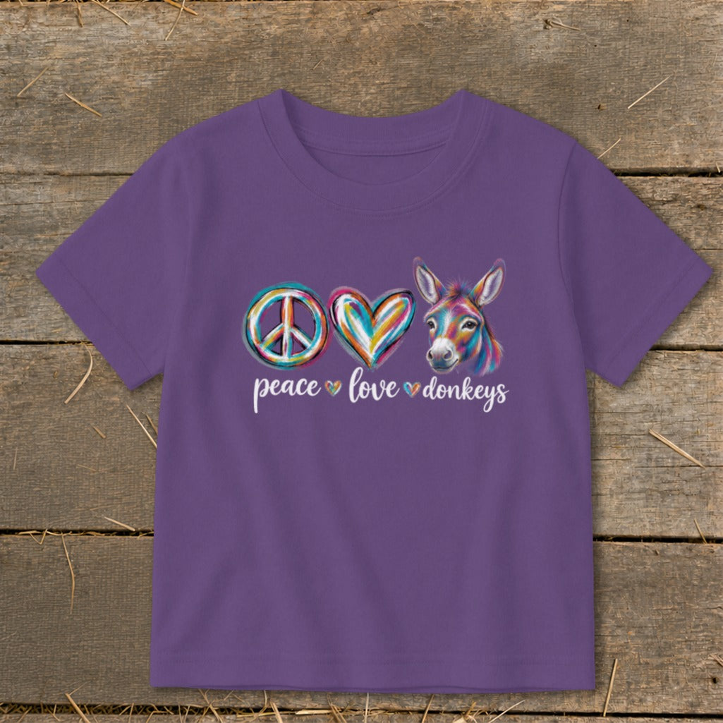 Purple t-shirt with peace sign, heart, and colorful donkey graphic; text reads "peace love donkeys".