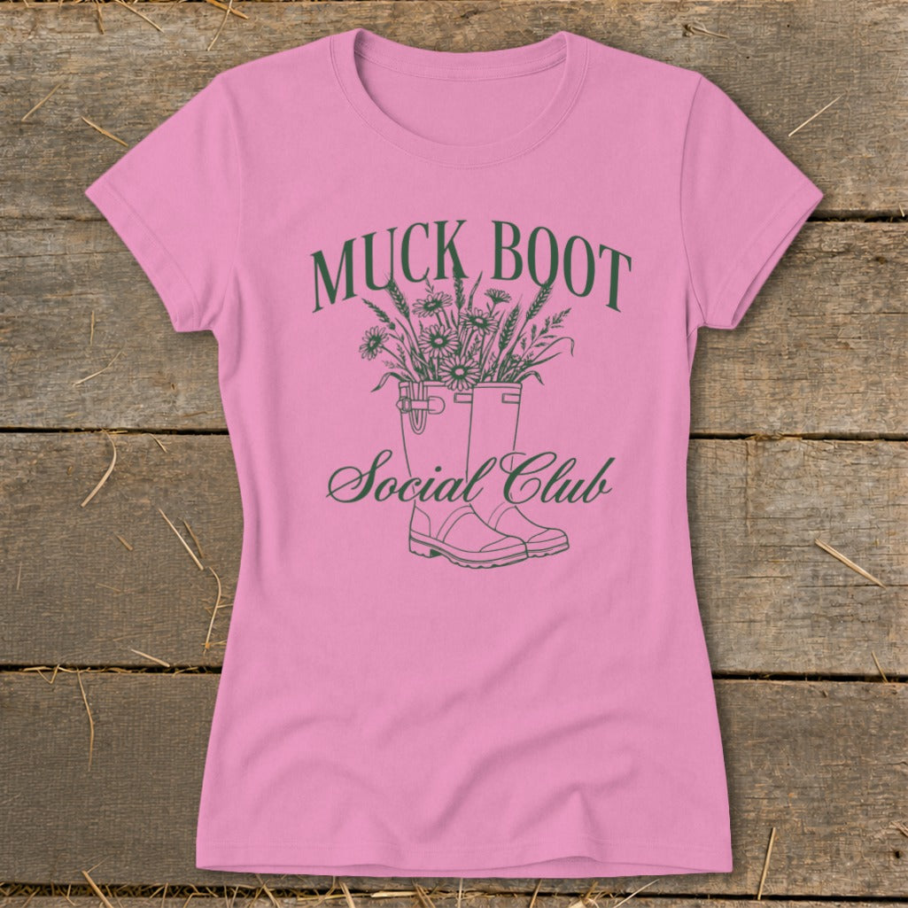 Pink t-shirt with Muck Boot Social Club graphic featuring boots with flowers.