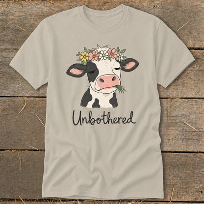 T-shirt with a cow wearing a flower crown and chewing grass, text says "Unbothered".