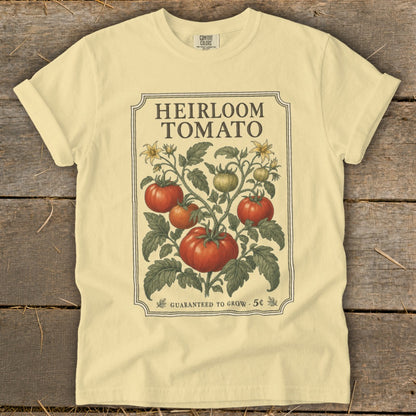 Light yellow t-shirt with "Heirloom Tomato" graphic and vintage botanical illustration.