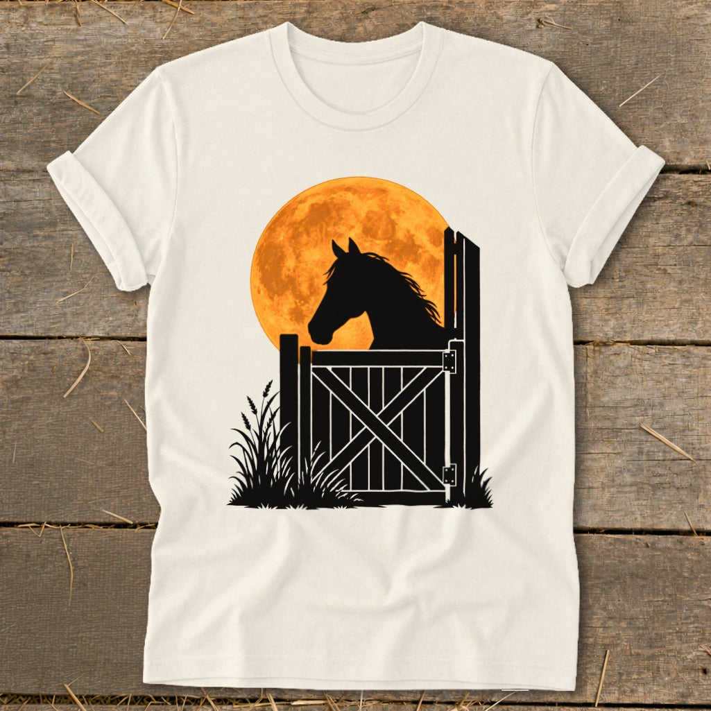 A white t-shirt featuring a graphic of a horse silhouetted against a large orange moon.